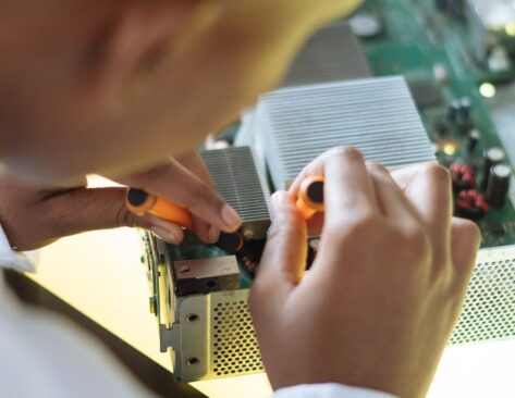 faceless professional repairer fixing video card in service center